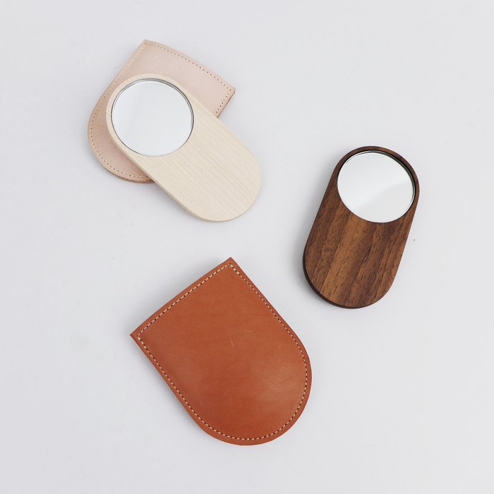 Shaped from solid walnut, these small mirrors are designed to sit comfortably in your hand by Heide Martin at the Center for Art in Wood