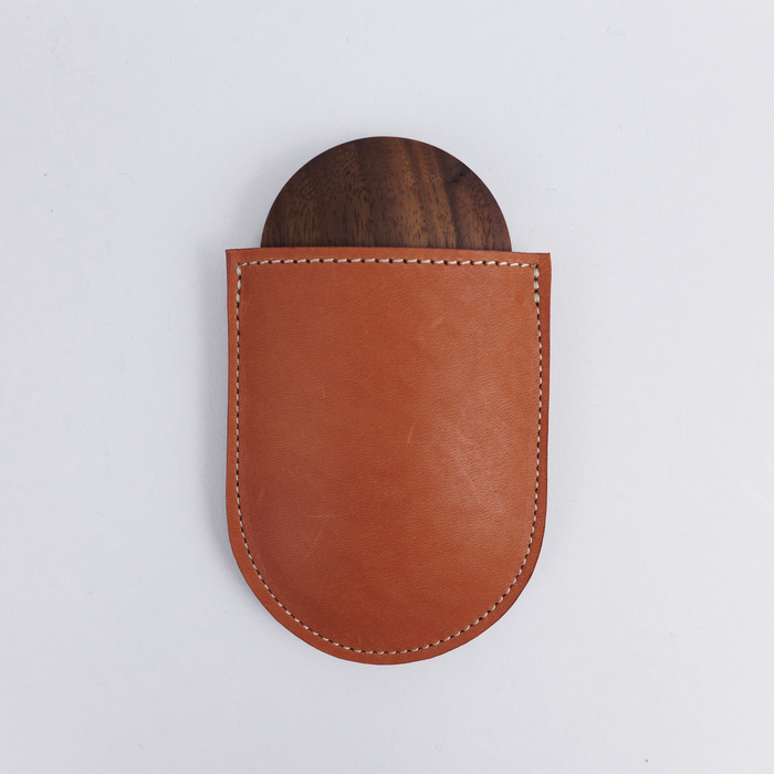 Shaped from solid walnut, these small mirrors are designed to sit comfortably in your hand by Heide Martin at the Center for Art in Wood