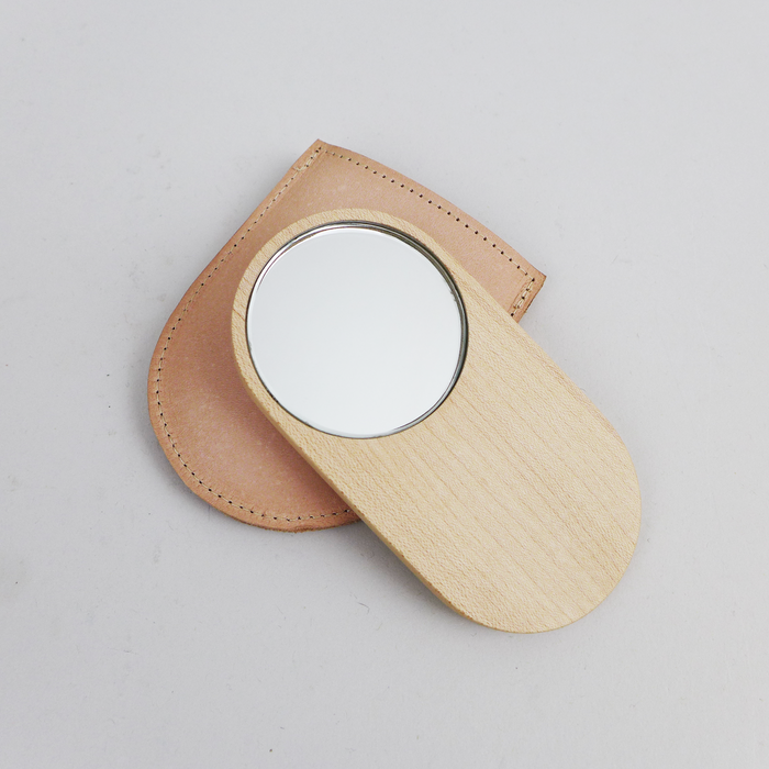 Shaped from solid walnut, these small mirrors are designed to sit comfortably in your hand by Heide Martin at the Center for Art in Wood